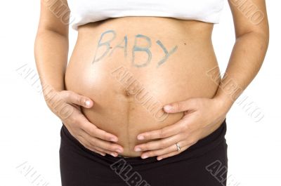 30 weeks pregnant teenager holding her belly with the word baby
