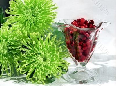 Red berry in glass and flowers