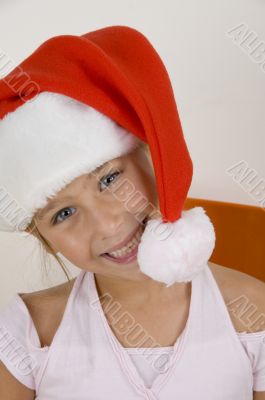 smiling little girl wearing christmas hat