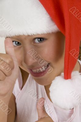 happy little girl wearing christmas hat