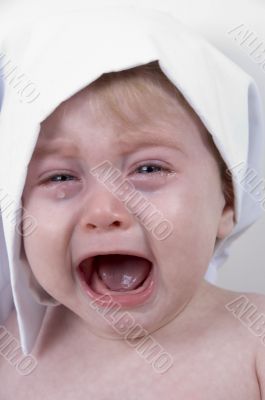weeping cute baby with chef cap and pot