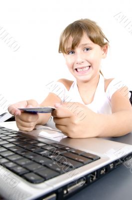 smiling girl with laptop and credit card