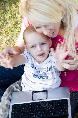 caring mother with laptop and her child