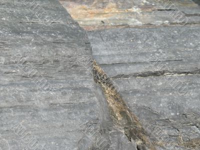 a dark grey rock close up background a dark grey rock close up background