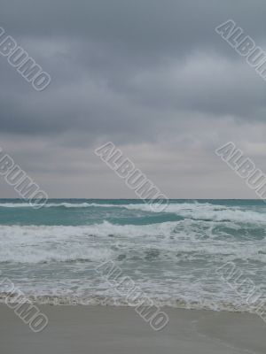 turquoise tropical ocean and dark sky