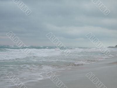 turquoise tropical ocean and dark sky