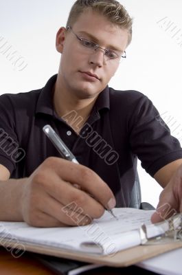 american man writing on notepad