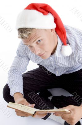 man holding book and looking upward