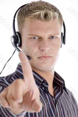 male with headset showing his index finger