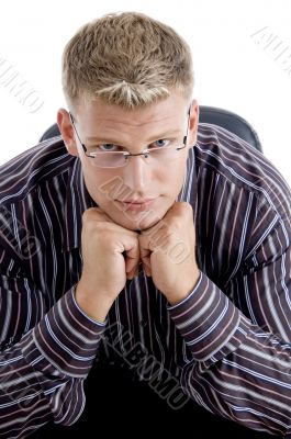 smart businessman with his chin resting his fists