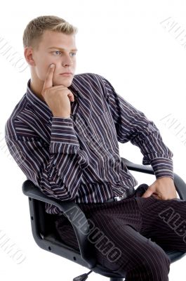 young caucasian sitting on chair thinking