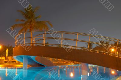 Swimming pool, night and palm trees