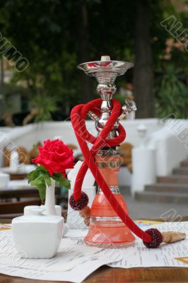 Hookah and red rose in vase