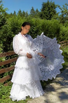 beautiful young woman, in a white dress with umbrella