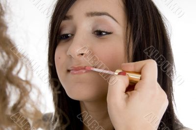 beautiful teen having makeup put on her