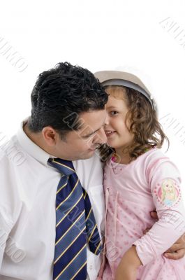 daughter whispering in his father`s ear
