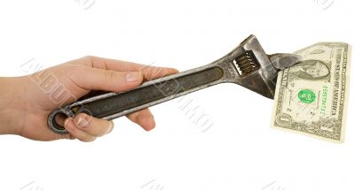 Wrench in a hand with dollar