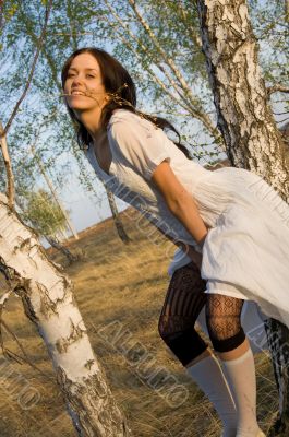 beauty girl sit on the birch tree