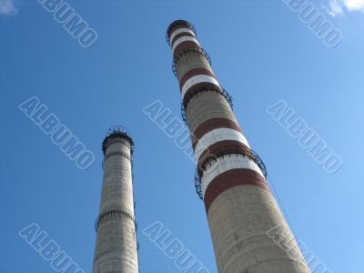 Two chimneys on the cloudy sky