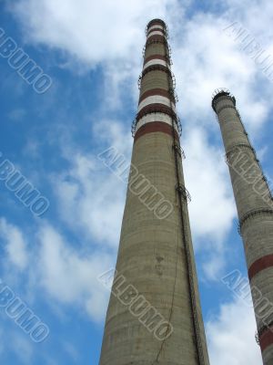 Two chimneys on the cloudy sky