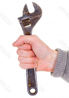 Big wrench in a man`s hand