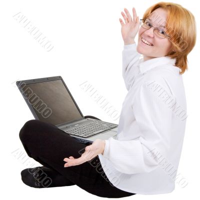 Woman sitting on a floor with the notebook
