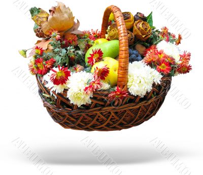 Wicker basket Autumn harvesting vegetables, fruits, leaves and flowers isolated over white background with shadow