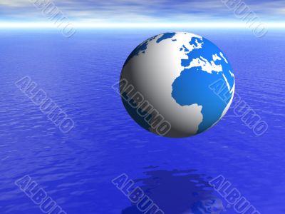 planet earth globe over blue ocean and cloudy sky