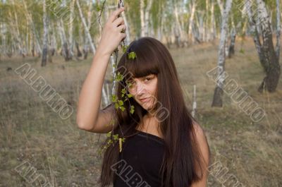 beauty girl stands with birch twigs 2