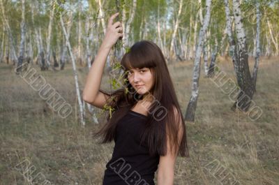 beauty girl stands with birch twigs