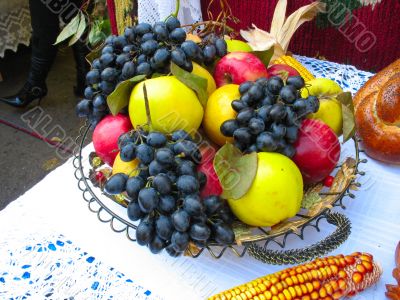 fruits grapes apples and corn on plate over a white canvas background