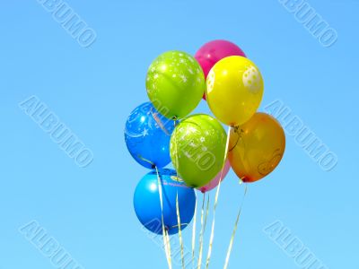 Bunch of colored party balloons against blue sky Bunch of colored party balloons against blue sky