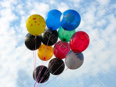 Bunch of colored party balloons against blue sky