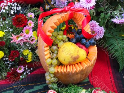 pumpkin basket with autumn harvest fruit and vegetables