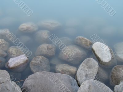 grey rock and green river