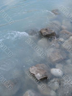 grey rock and green river