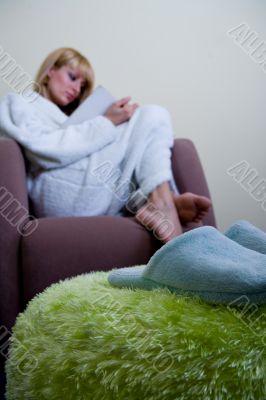 Morning slippers in front of reading woman