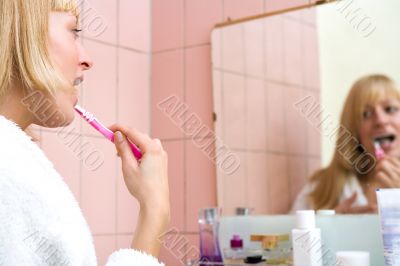Paris Hilton look-a-like brushing her teeth