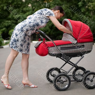 Woman with baby carriage Woman with baby carriage