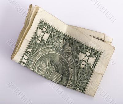 one crumpled one dollar banknote