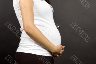 30 weeks pregnant teenager holding her belly