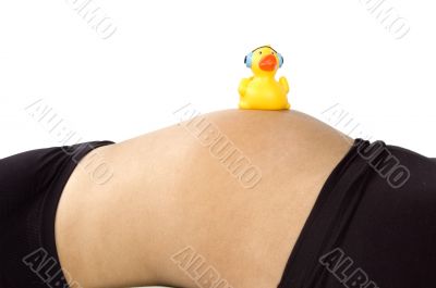 30 weeks pregnant teenager with music duck on her belly