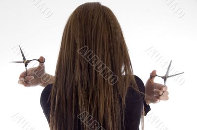 back pose of female with scissors