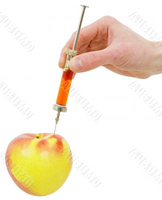 Hand with a syringe and apple