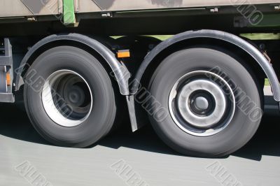 Big blurred lorry wheels on the move