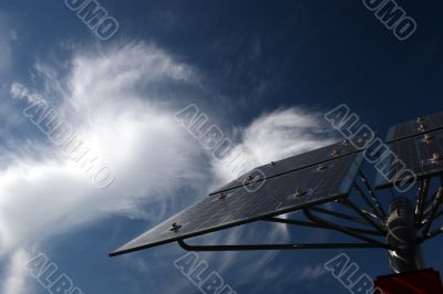 Solar panels in front of bizarre cirrus clouds