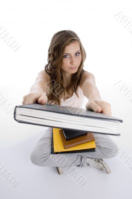 sitting girl showing book