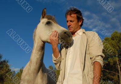 man and grey horse
