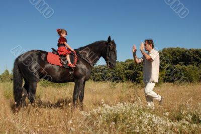 father, daughter and horse