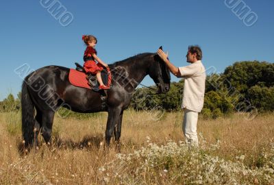 father, daughter and horse